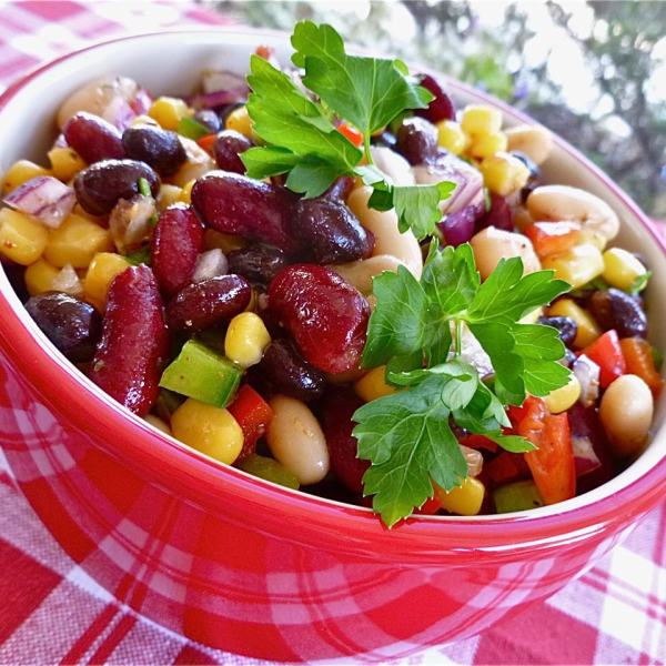 Mexican-style salad with three types of beans, peppers and corn