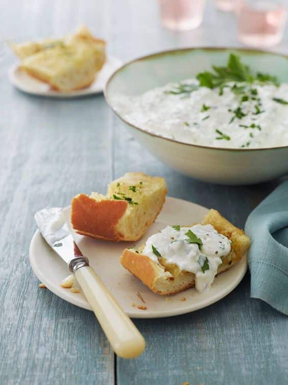Fresh baguette with cottage cheese and parsley spread.