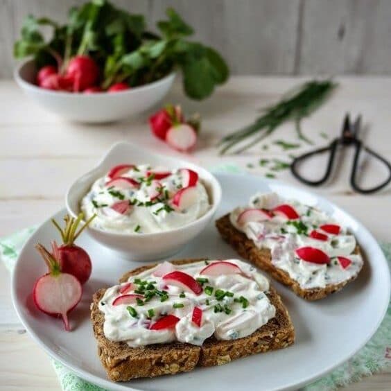 Bread spread with radish spread and sprinkled with chives.