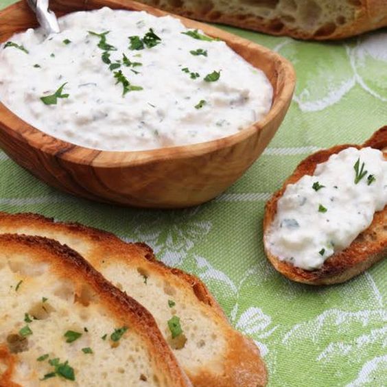 Toasts with cheese spread and herbs.