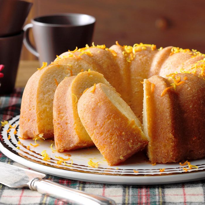 Buttermilk cake sprinkled with citrus peel cut on a plate.