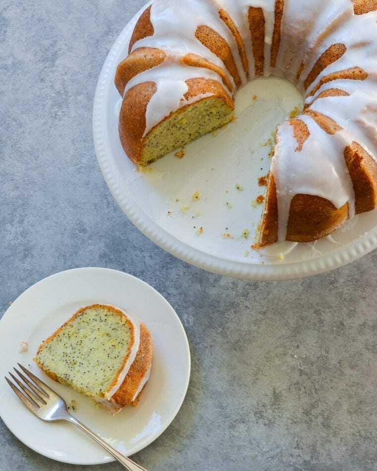 Poppy seed cake topped with lemon glaze on a plate.