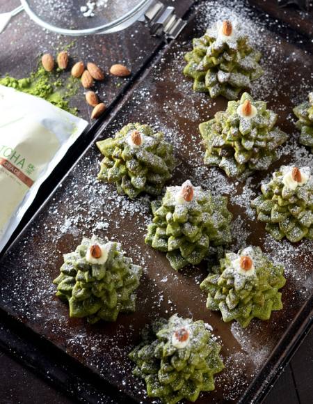 Christmas cookies in the shape of trees with matcha tea, almonds and white chocolate.