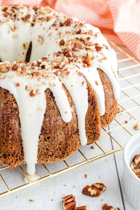 Carrot cake with frosting and chopped nuts.