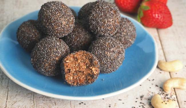 Unbaked Christmas balls with poppy seeds, dates and nuts.