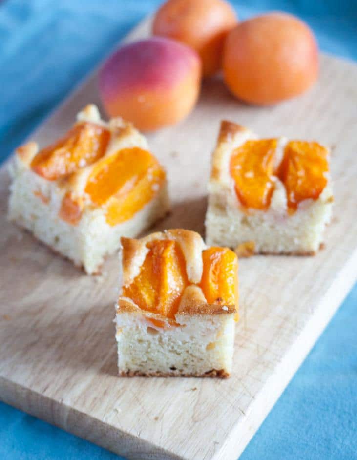 Apricot cake with yogurt, cut on a cutting board.