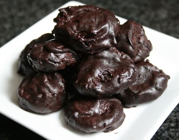 Prunes pickled in rum and topped with chocolate glaze.
