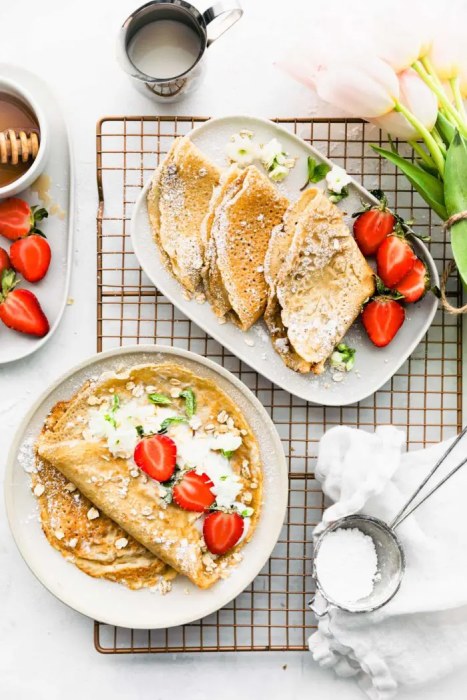 Pancakes with flakes decorated with yogurt and strawberries.