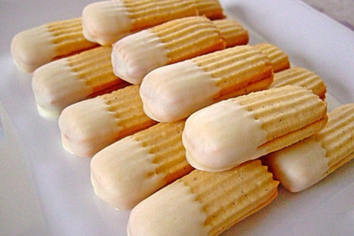 Custard cookies from a machine with white chocolate.