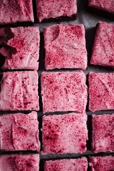 Beetroot slices decorated with mascarpone glaze and beetroot powder.