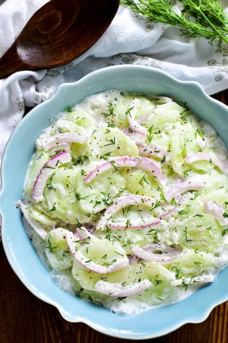 Salad prepared from salad cucumber, sour cream and dill.
