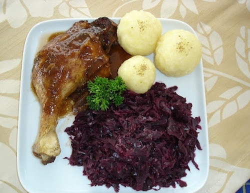 Roast duck with red cabbage and potato dumplings.