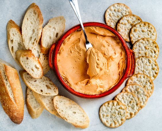 Cheese spread with baguette and crackers.