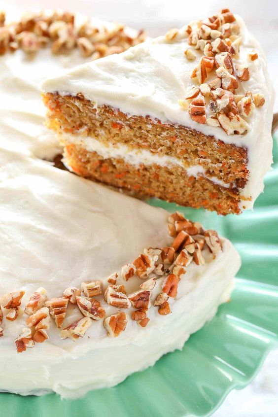 Birthday carrot cake with chopped nuts.