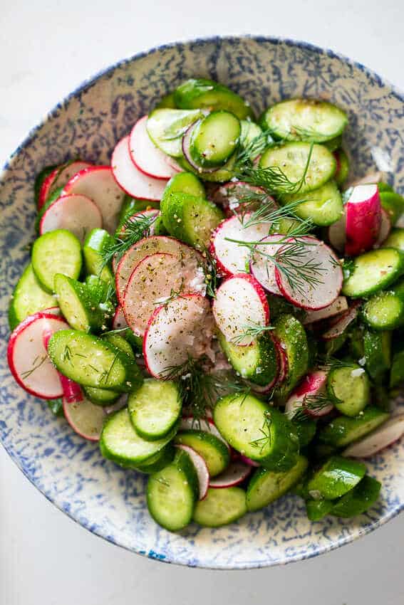 Cucumber and radish salad served on a plate.