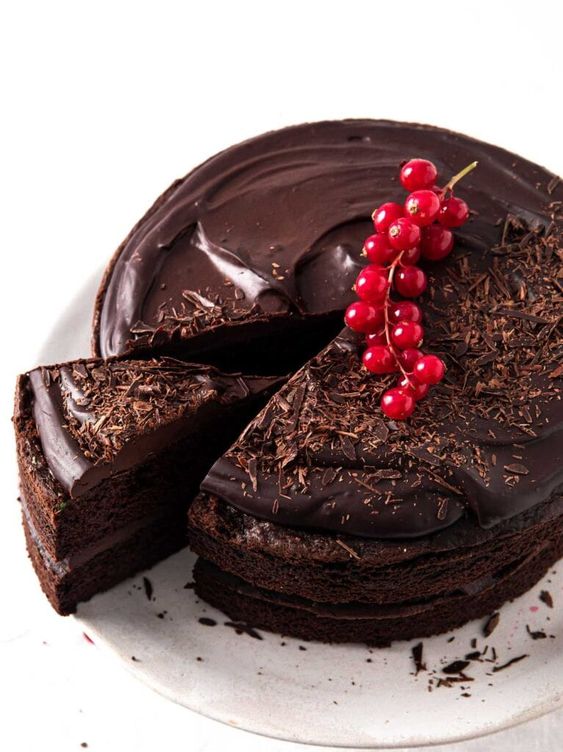 Chocolate birthday cake with currants on top.