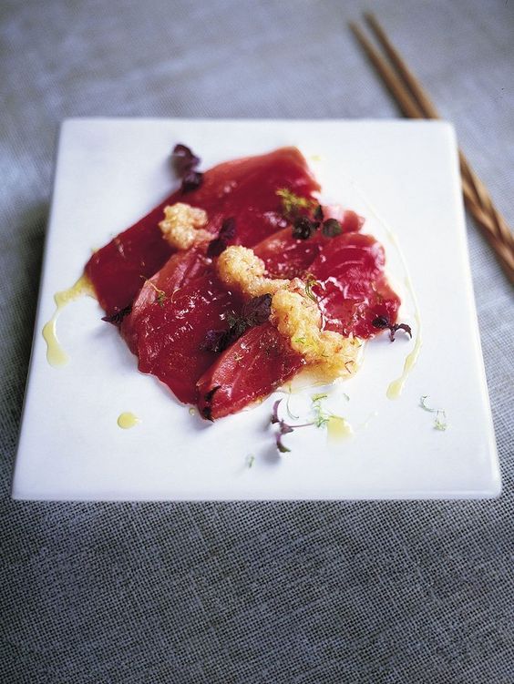 Delicious tuna marinated in a mixture of spices and served with herb oil.