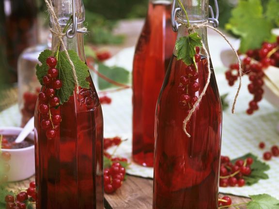 Currant syrup in glass bottles.