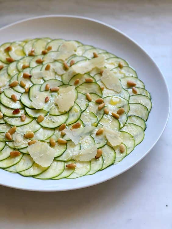 Thinly sliced zucchini seasoned with lemon, parmesan and pine nuts.