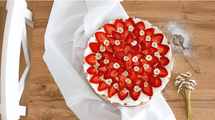 Unbaked sponge cake, cream and strawberries.