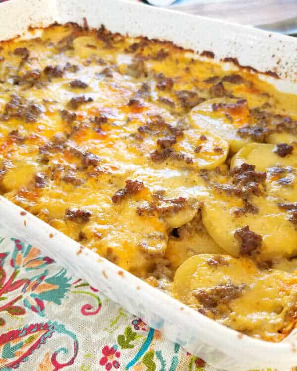 Baked minced meat with potatoes, onions and cream in a baking dish.