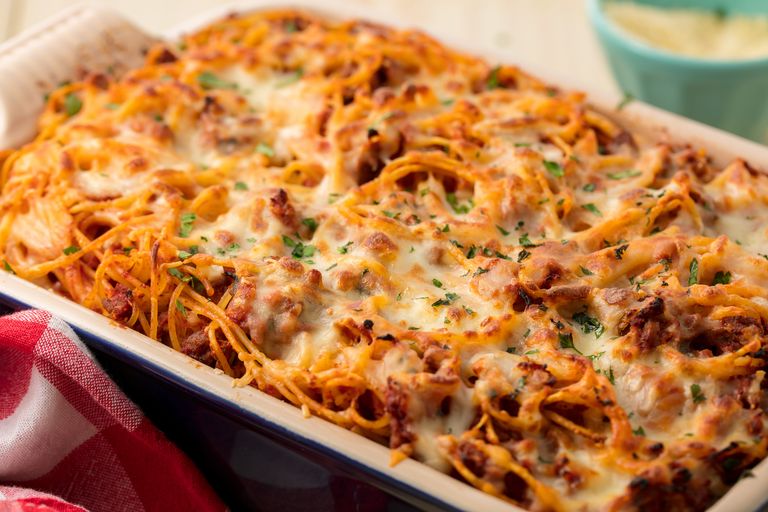 Baked pasta with tomato sauce, minced meat and cheese in a baking dish.