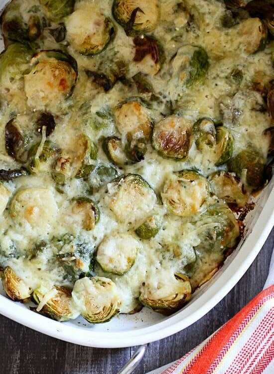 Baked Brussels sprouts with a light Parmesan and Gruyere cheese sauce, served in a baking dish.