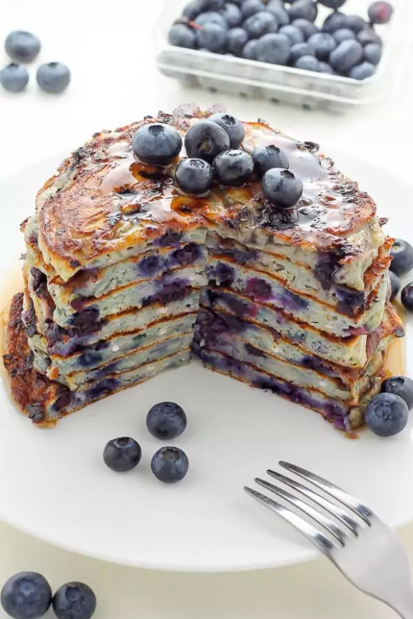 Blueberry cottage cheese pancakes stacked on top of each other.