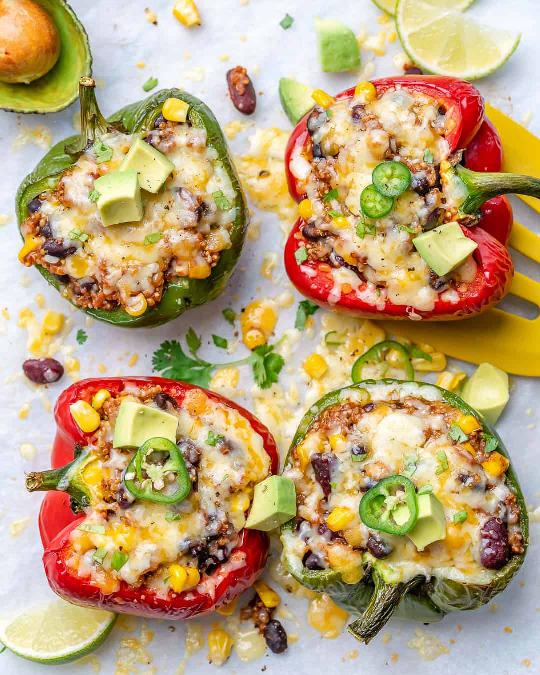 Peppers stuffed with a mixture of quiona and beans, baked with cheese and garnished with avocado and chili.