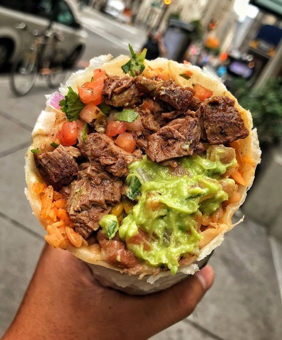 Mexican tortilla filled with rice, steak meat and avocado.