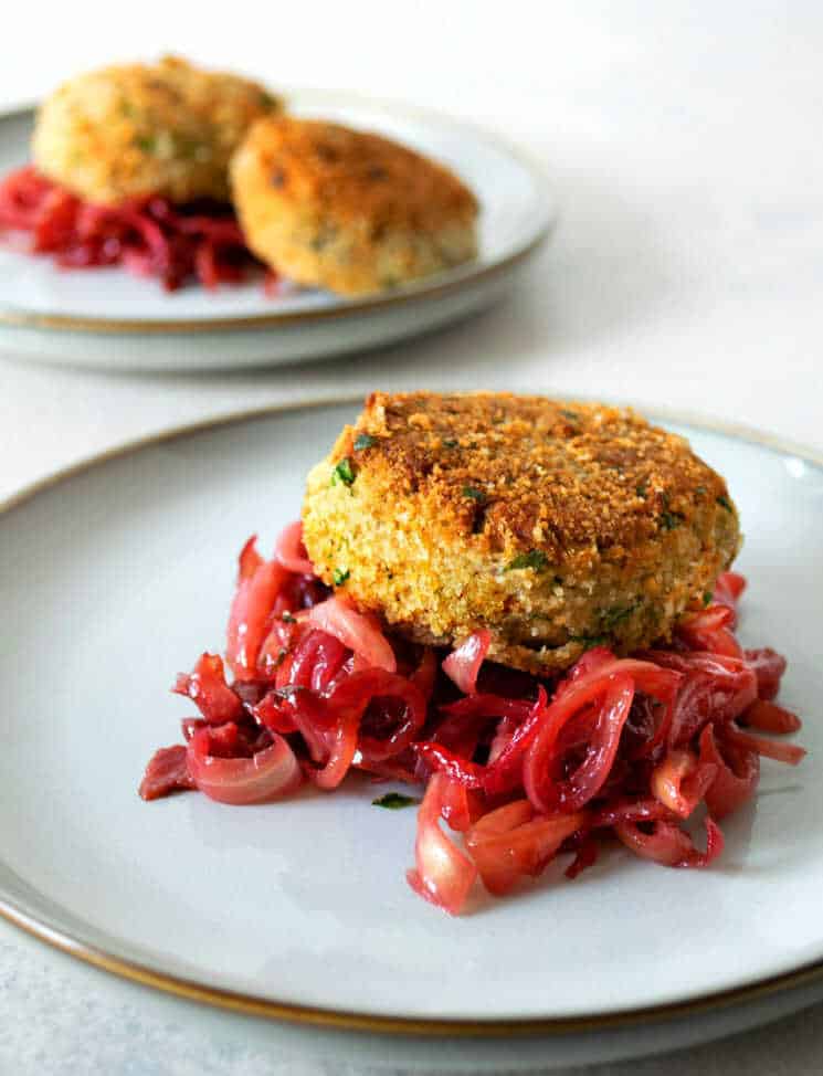 Polish-style fish meatballs with onions prepared in a delicious cherry jam sauce served on plates.