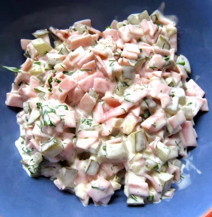 A cold dish made from soft salami, sterilized cucumbers and onions.
