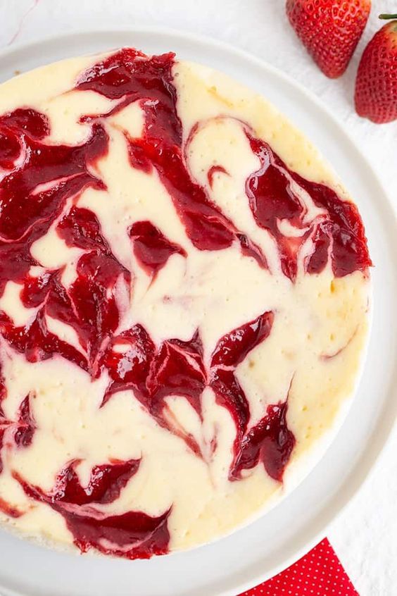 Creamy cheesecake with strawberries and a cream cheese crust.