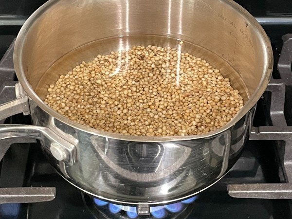 Cooking sorghum in a pot on the stove.
