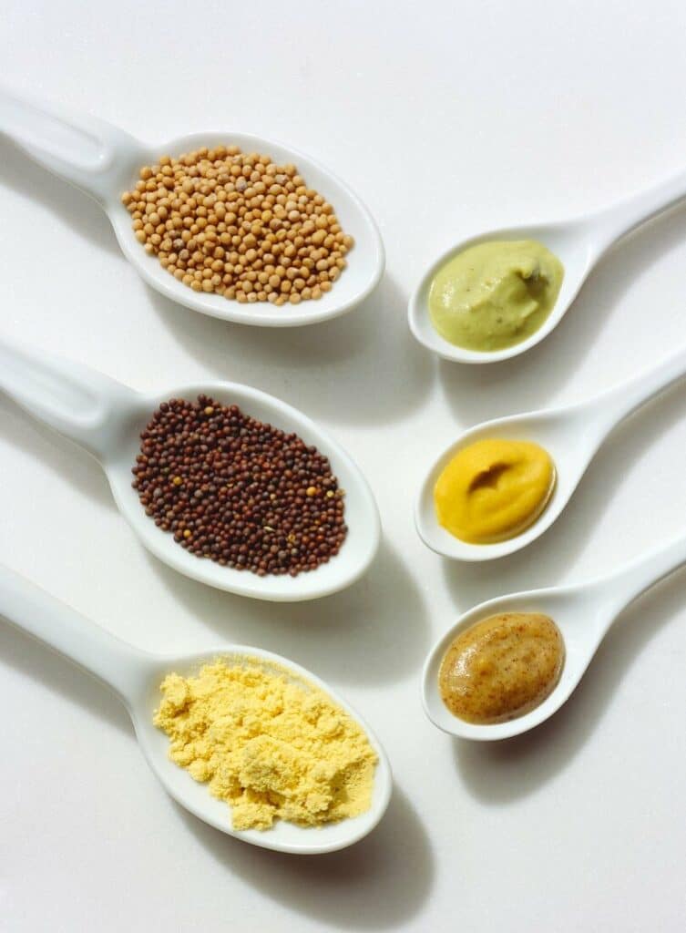 Verschiedene Arten von Samen, einschließlich unterschiedlicher Verarbeitung und Arten von Senf.