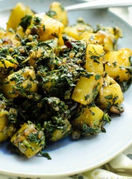 Plate with potatoes and fenugreek leaves.