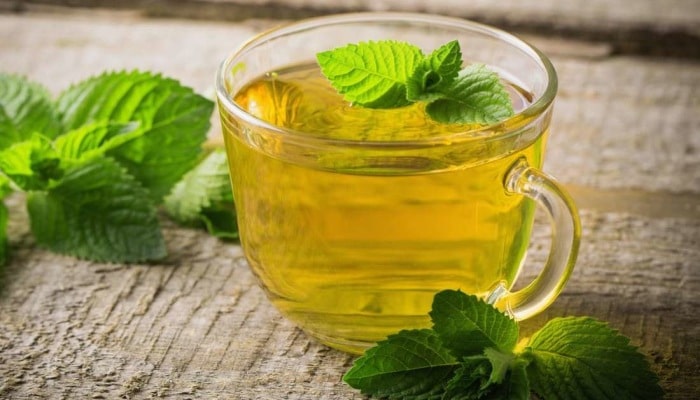 A cup of mint tea made from fresh mint.