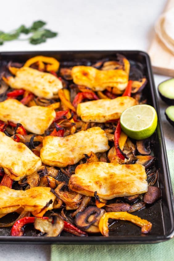 Cheese baked on a baking sheet with lots of delicious vegetables.
