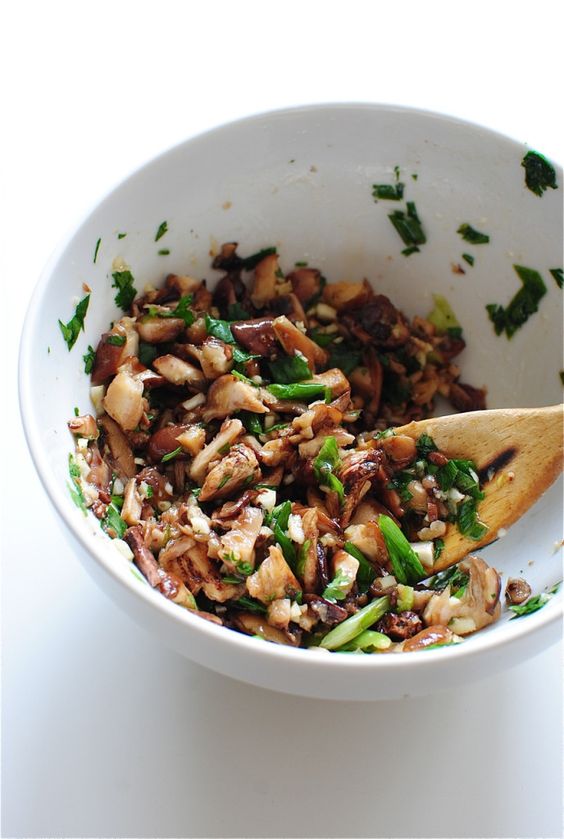 Sauteed mushrooms in one bowl with vegetables.