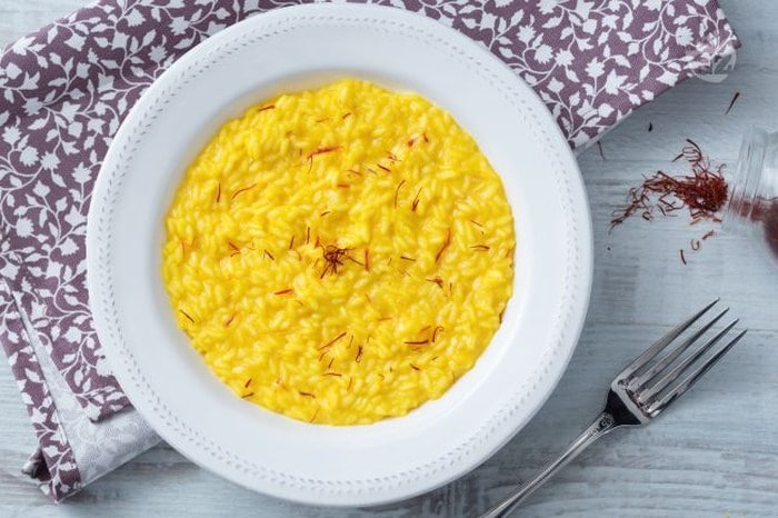 Plate with yellow saffron risotto.