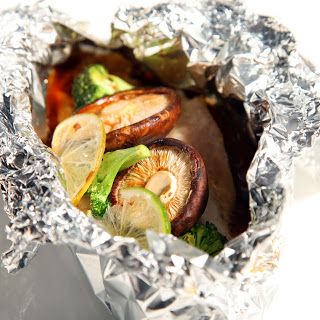 Mushrooms packed in a foil package with vegetables.