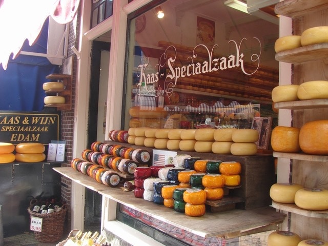A small shop with a wide selection of waxed cheese.