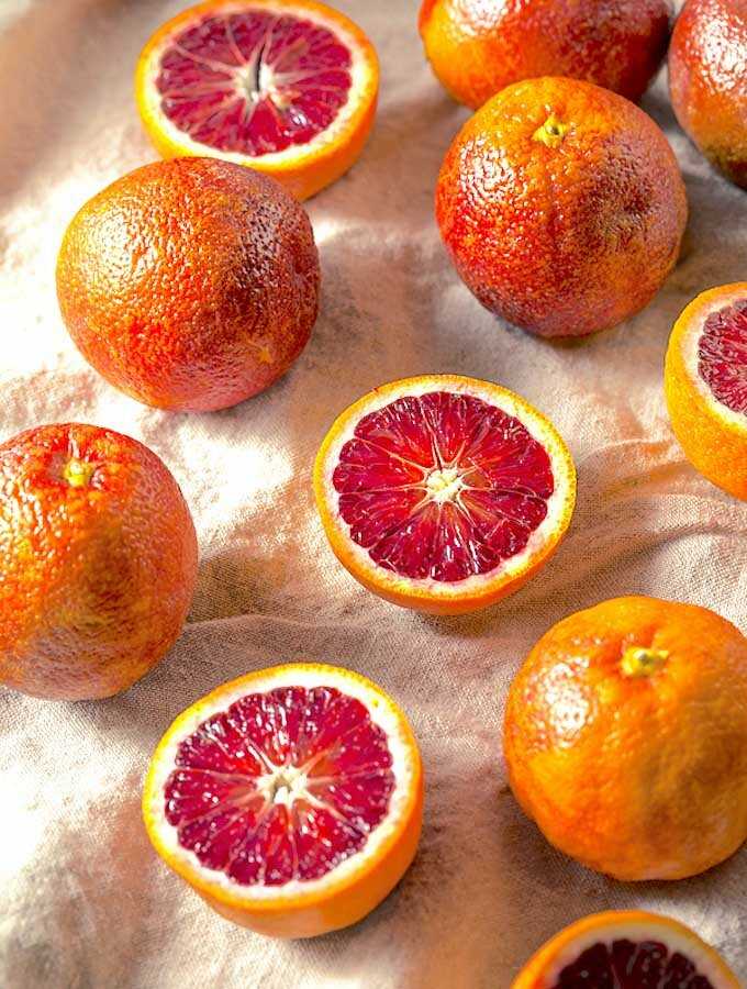 Whole and halved blood oranges.