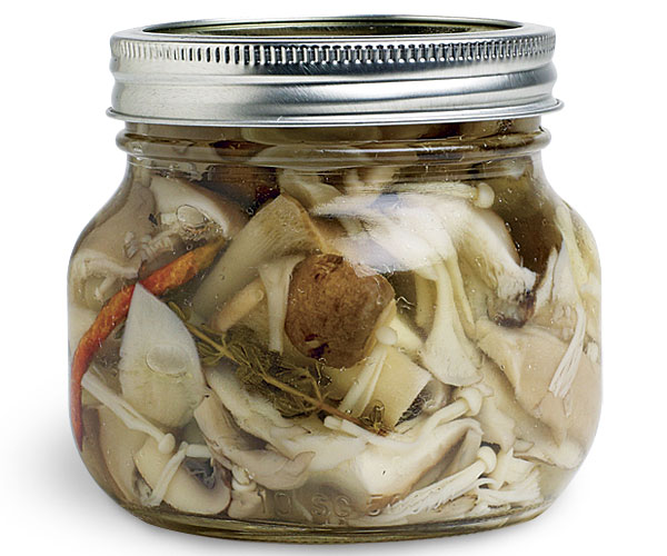 Pickled mushrooms in a mason jar.