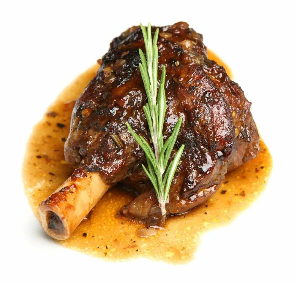 Stewed leg of lamb garnished with a sprig of rosemary.