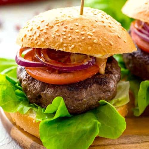 Burger filled with ground beef and vegetables.