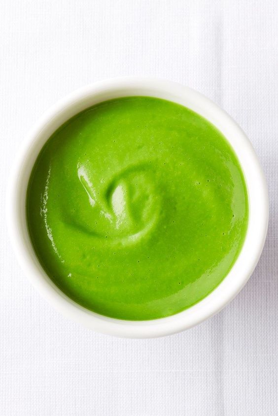 A bowl full of delicious green fresh pea cream.