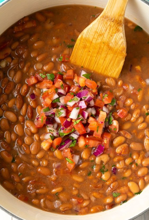 A pan full of hot beans with chilli, onion and paprika.