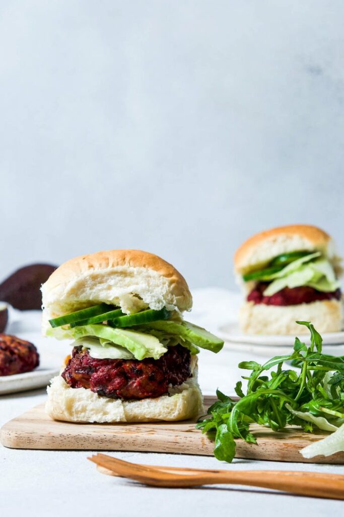 Small burgers filled with beef patty and beetroot and vegetables.