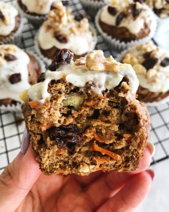 Fluffy, bite-sized muffin with frosting and nuts.